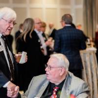 President Emeritus Don Lubbers shaking hands with a guest.